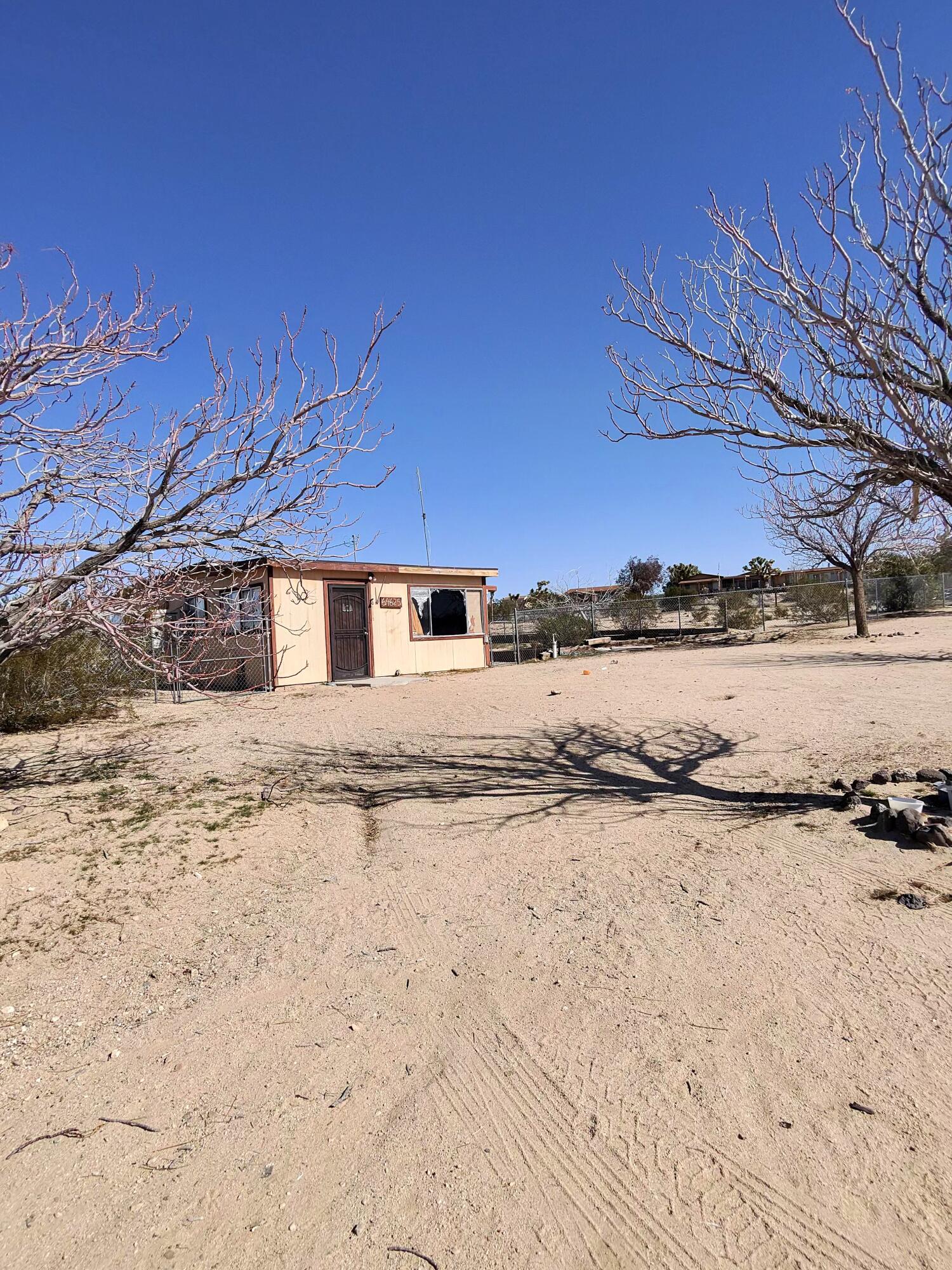 64625 Sonora Road Joshua Tree, CA 92252 - Photo 17 of 17 a view of a yard with wooden fence