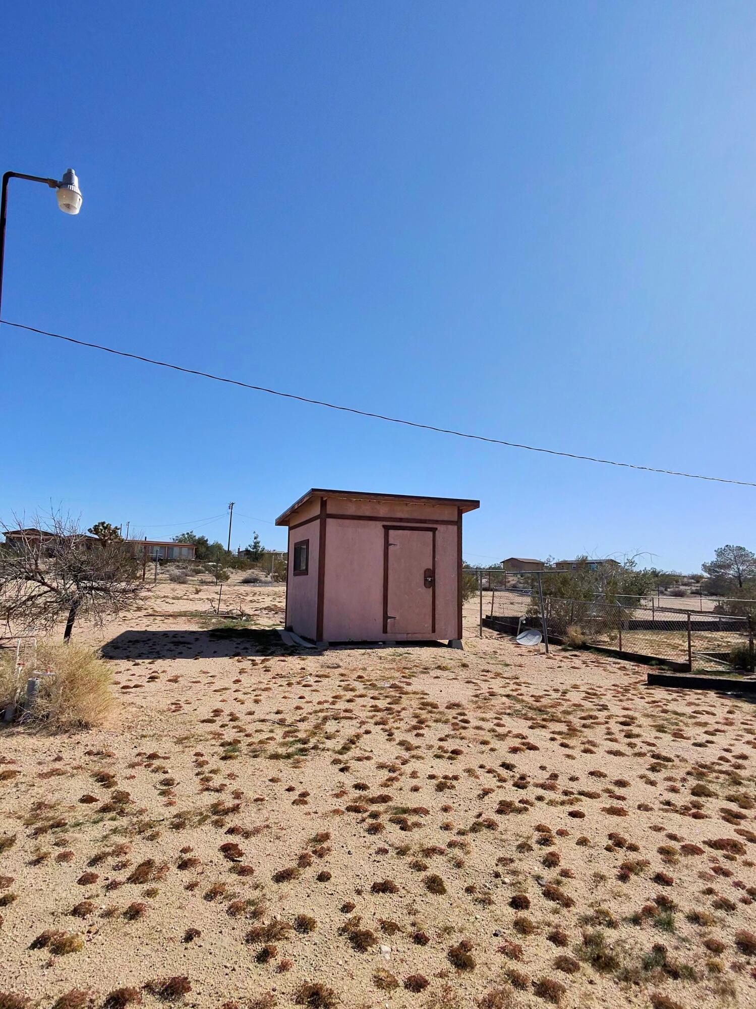 64625 Sonora Road Joshua Tree, CA 92252 - Photo 6 of 17 a view of a dry yard with a house