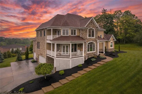 a front view of a house with a garden
