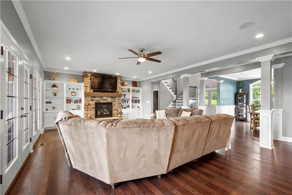 1272 McEwen Road Canonsburg, PA 15317 - Photo 9 of 50 A spacious living area featuring hardwood floors,large windows allowing natural light, and a Heat NGlo gas fireplace with stone surround and custombuilt-ins.
