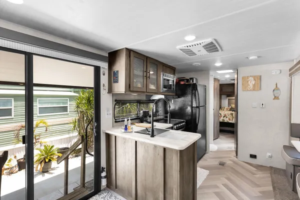 a kitchen with stainless steel appliances granite countertop a sink refrigerator and cabinets