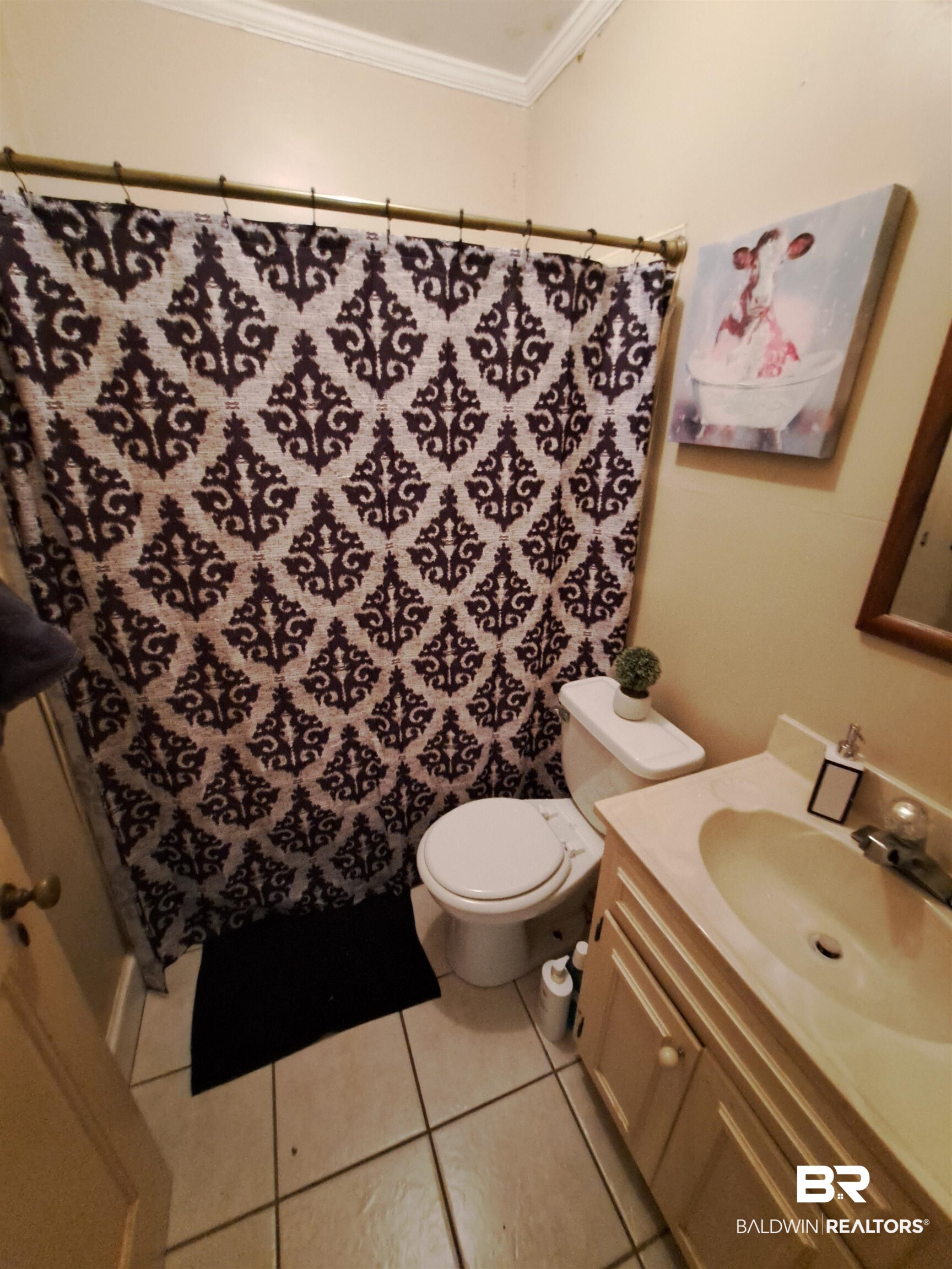 309 Bellview Avenue Evergreen, AL 36401 - Photo 22 of 27 Full bathroom featuring a shower with curtain, vanity, crown molding, and light tile patterned flooring