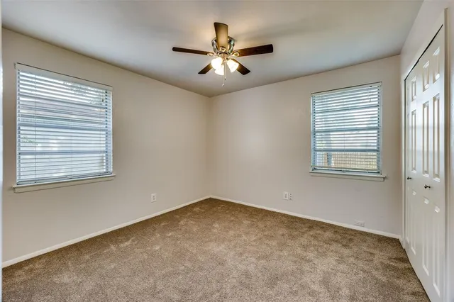 a view of a room with window and ceiling fan