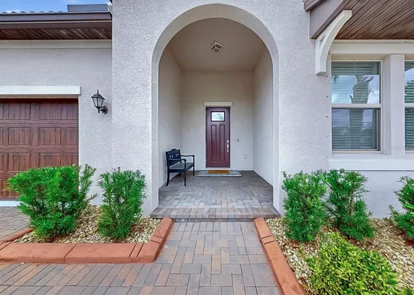 a view of a hallway view with wooden floor and a chandelier