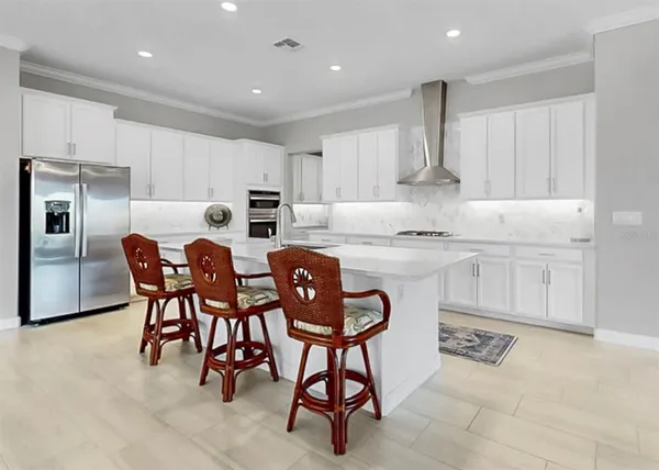 a kitchen with white cabinets and appliances
