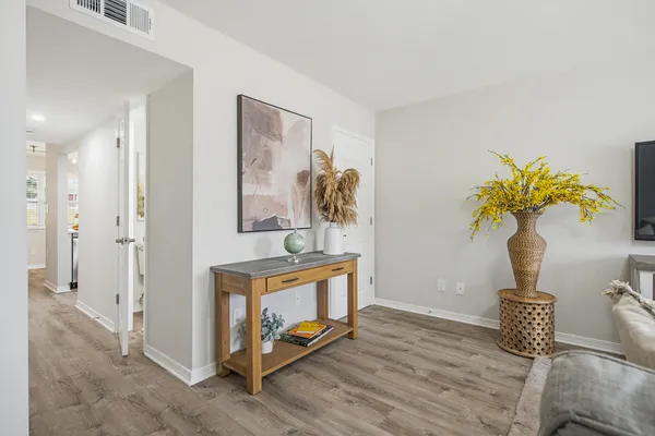 a living room with furniture and a chandelier