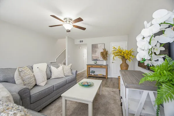 a living room with furniture and a chandelier