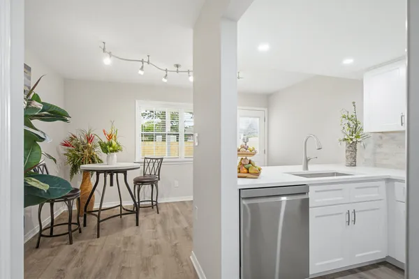 a kitchen with stainless steel appliances granite countertop a sink stove and cabinets