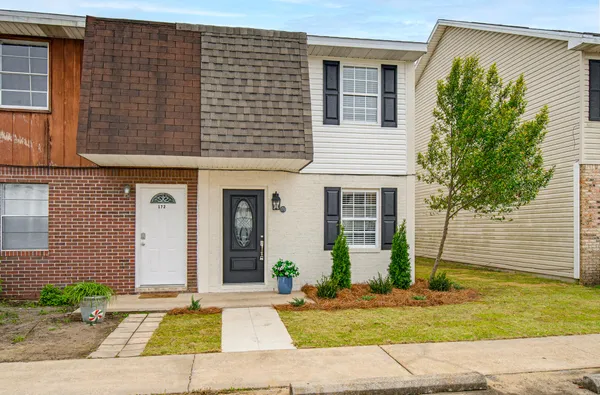 a front view of a house with a yard