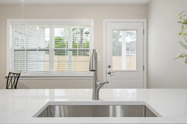 an empty room with a window and ceiling fan