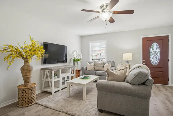 a living room with furniture and a chandelier