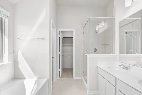 a kitchen with kitchen island white cabinets and refrigerator