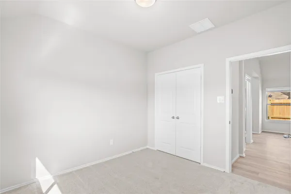 a bed room with a bed and a window