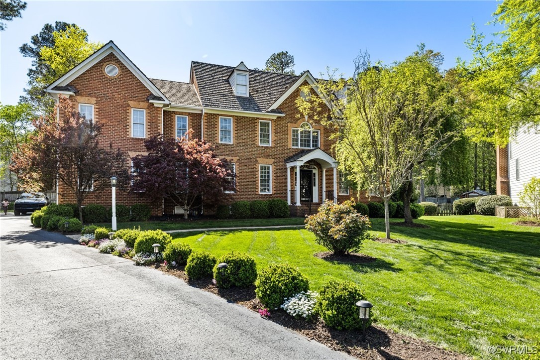3813 Hackamore Lane Henrico, VA 23233 - Photo 5 of 45 a front view of a house with a garden and swimming pool