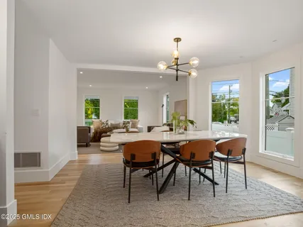 a view of a dining room with furniture and wooden floor