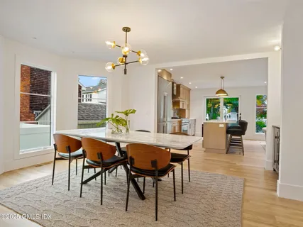 a view of a dining room with furniture window and wooden floor