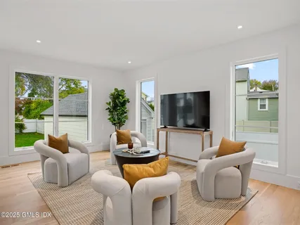 a kitchen with a stove a sink a dining table and chairs