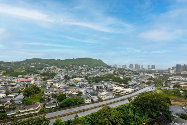 an aerial view of residential houses with city view