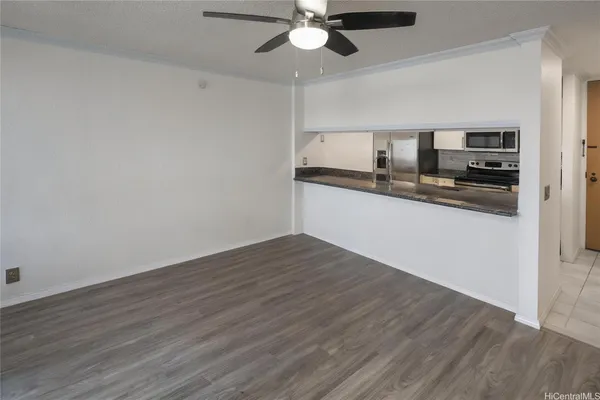 a kitchen with stainless steel appliances a wooden floor a window and a sink