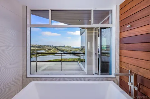 a bedroom with bed and glass windows