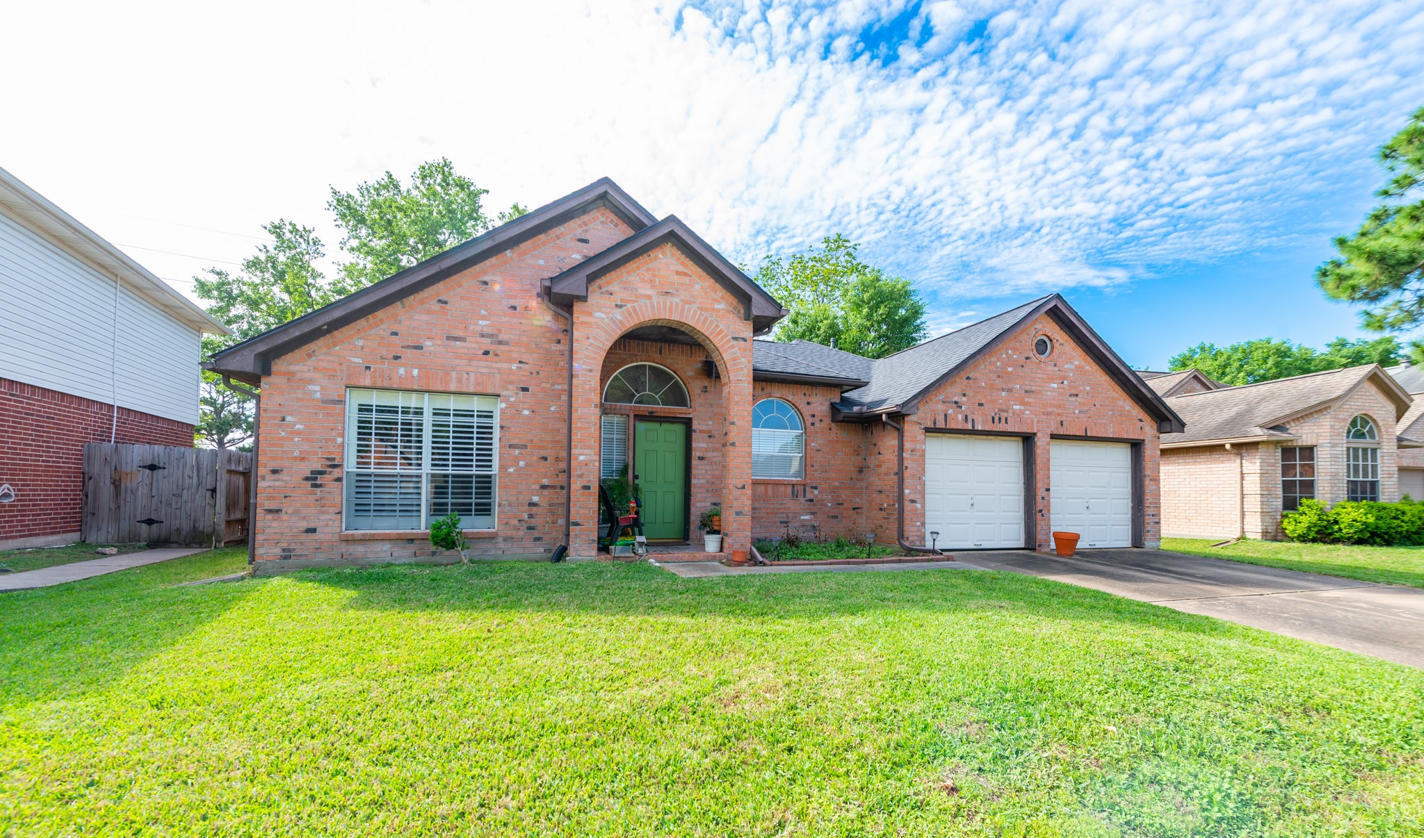 12203 Canterhurst Way Houston, TX 77065 - Photo 2 of 23 a front view of a house with a yard and garage