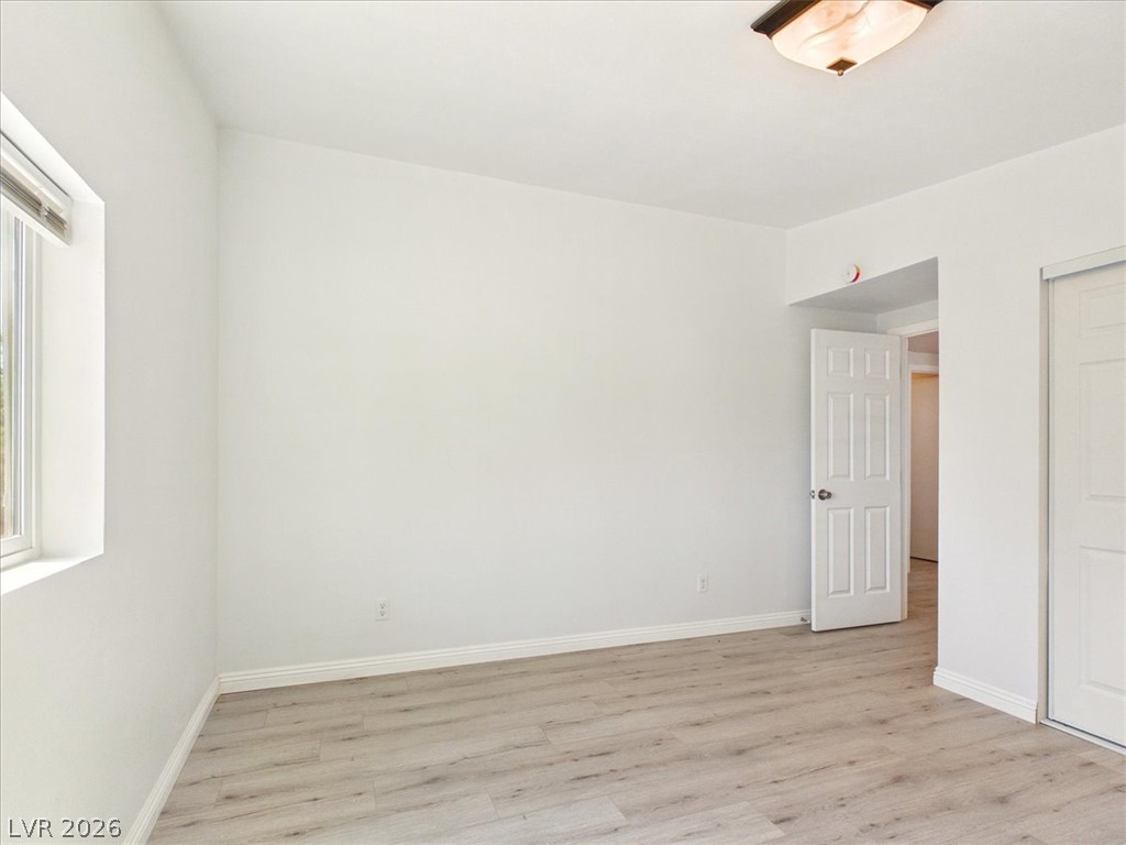 4081 Retread Road Pahrump, NV 89048 - Photo 50 of 98 A well-lit bedroom features durable laminate flooring and a bright window.