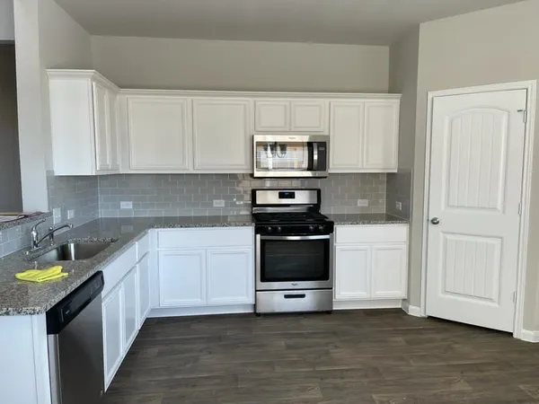 a kitchen with a sink and a stove top oven