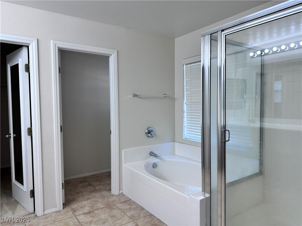 9676 Ridgebluff Avenue Las Vegas, NV 89148 - Photo 14 of 15 Full bathroom with a stall shower, a garden tub, and light tile patterned floors