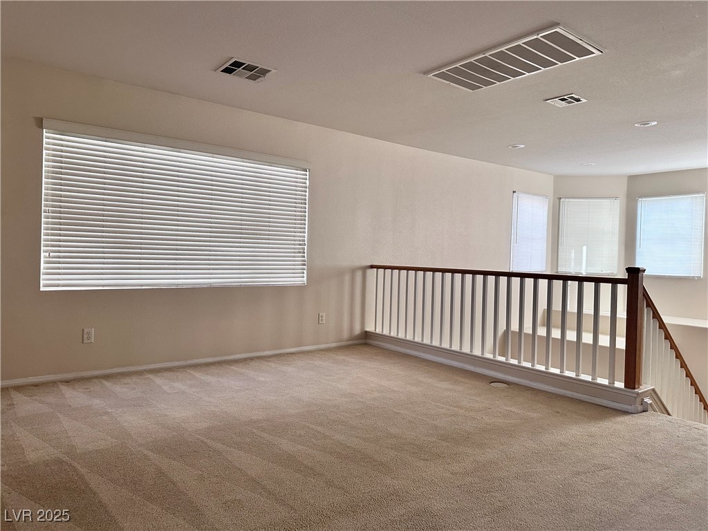 9676 Ridgebluff Avenue Las Vegas, NV 89148 - Photo 10 of 15 Spare room with light colored carpet and baseboards