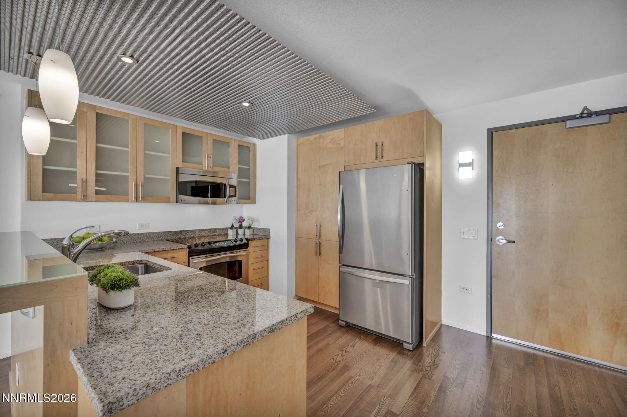 255 North Sierra Street, Unit 1208 Reno, NV 89501 - Photo 13 of 37 a kitchen with stainless steel appliances granite countertop cabinets and wooden floor
