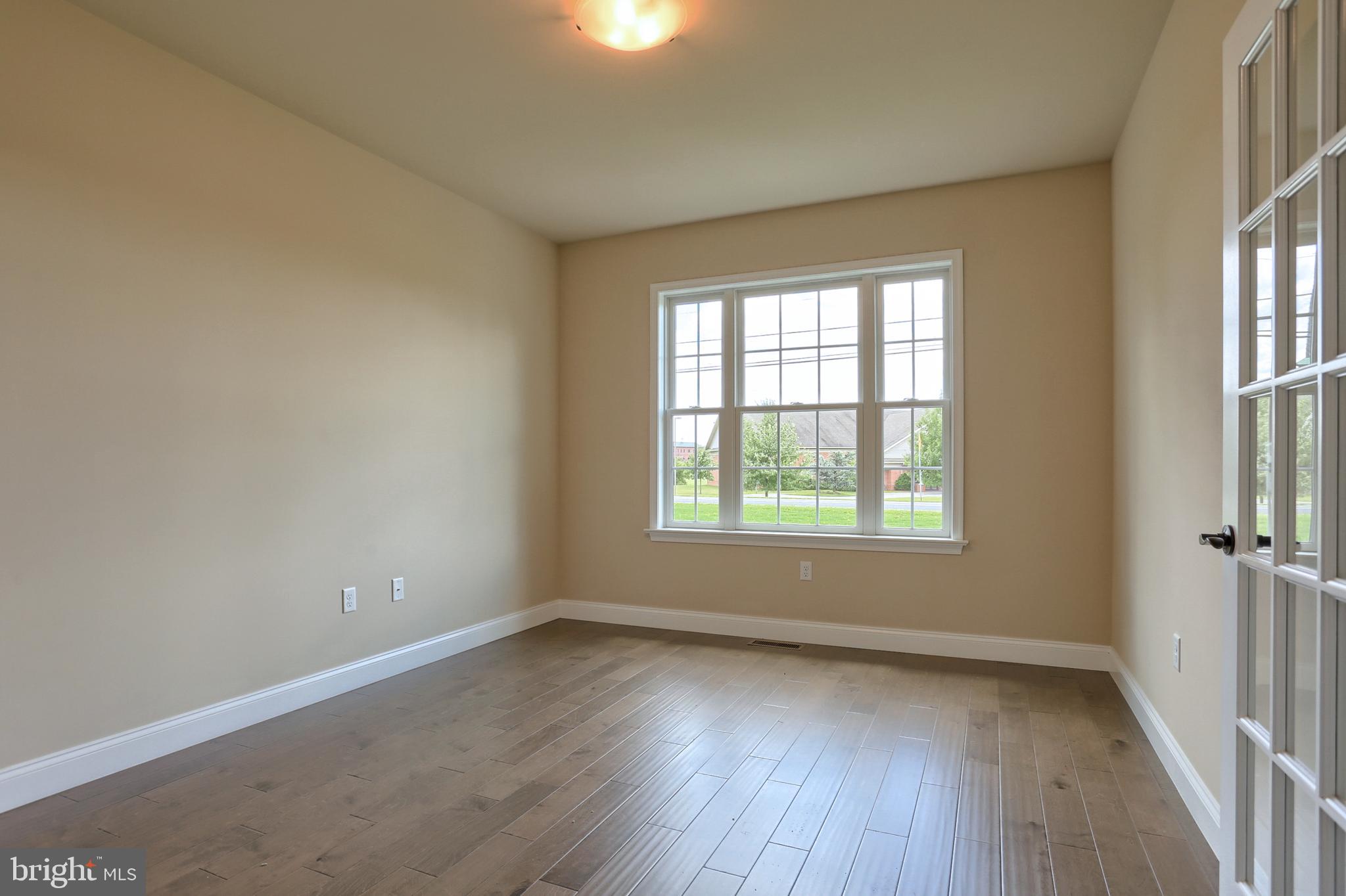 22 Rolling Meadow Road Lebanon, PA 17046 - Photo 11 of 38 an empty room with wooden floor and windows