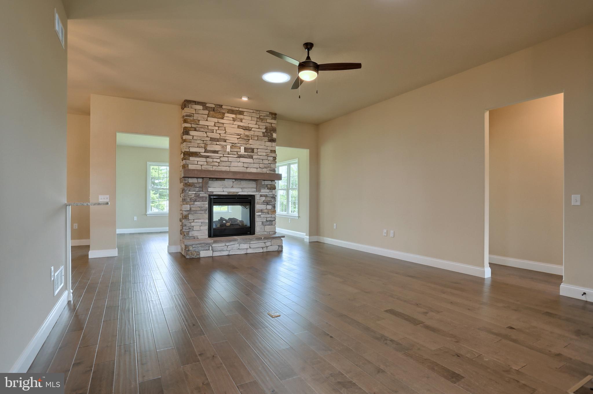 22 Rolling Meadow Road Lebanon, PA 17046 - Photo 12 of 38 an empty room with wooden floor fireplace fan and windows