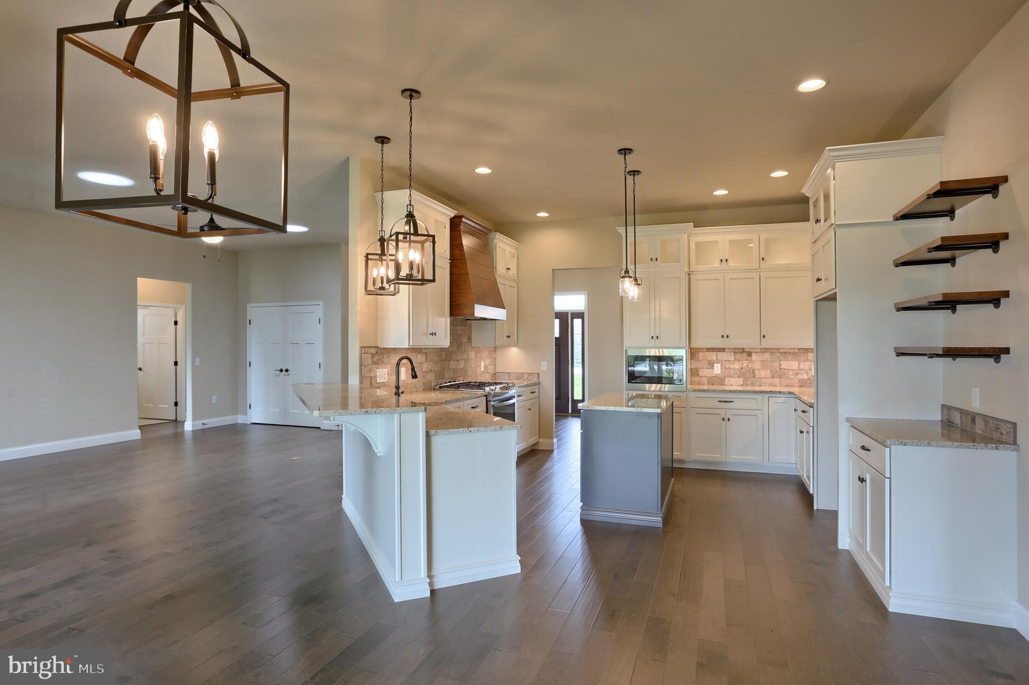 22 Rolling Meadow Road Lebanon, PA 17046 - Photo 18 of 38 a large kitchen with stainless steel appliances kitchen island a large counter space a sink and a fireplace