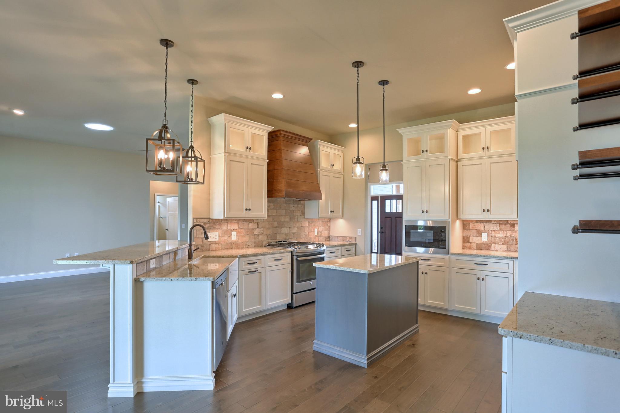 22 Rolling Meadow Road Lebanon, PA 17046 - Photo 19 of 38 a open kitchen with stainless steel appliances granite countertop a sink a stove and a refrigerator