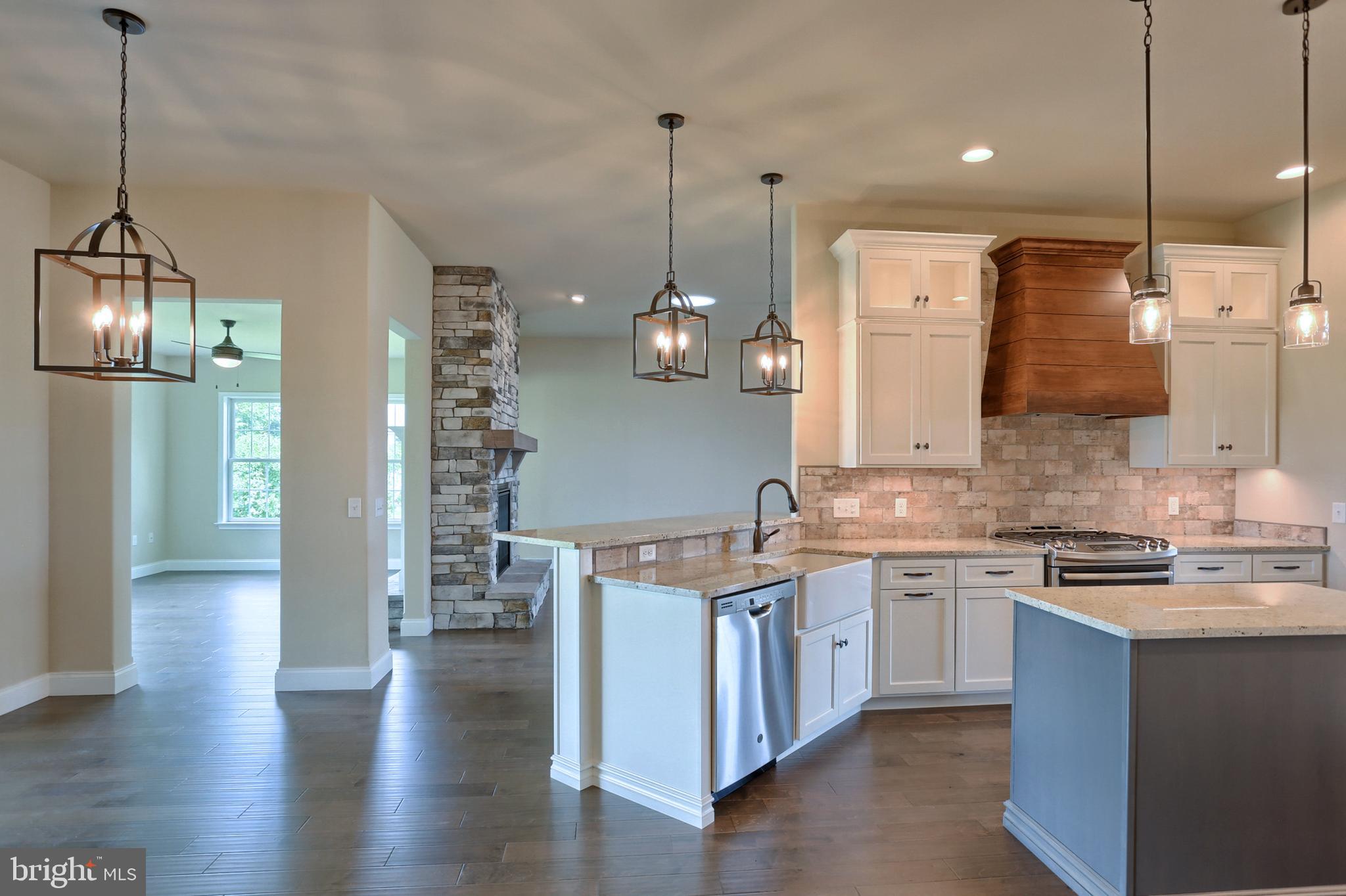 22 Rolling Meadow Road Lebanon, PA 17046 - Photo 20 of 38 a kitchen with stainless steel appliances granite countertop wooden floors sink stove and cabinets