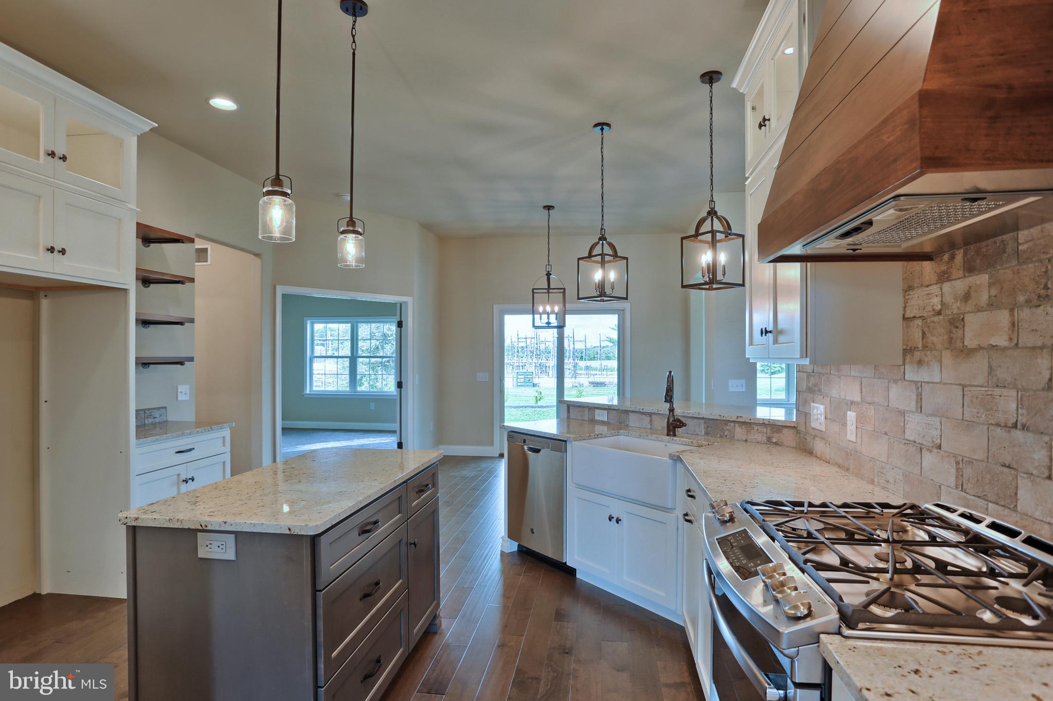 22 Rolling Meadow Road Lebanon, PA 17046 - Photo 22 of 38 a kitchen with stainless steel appliances granite countertop a sink a stove and a wooden floors