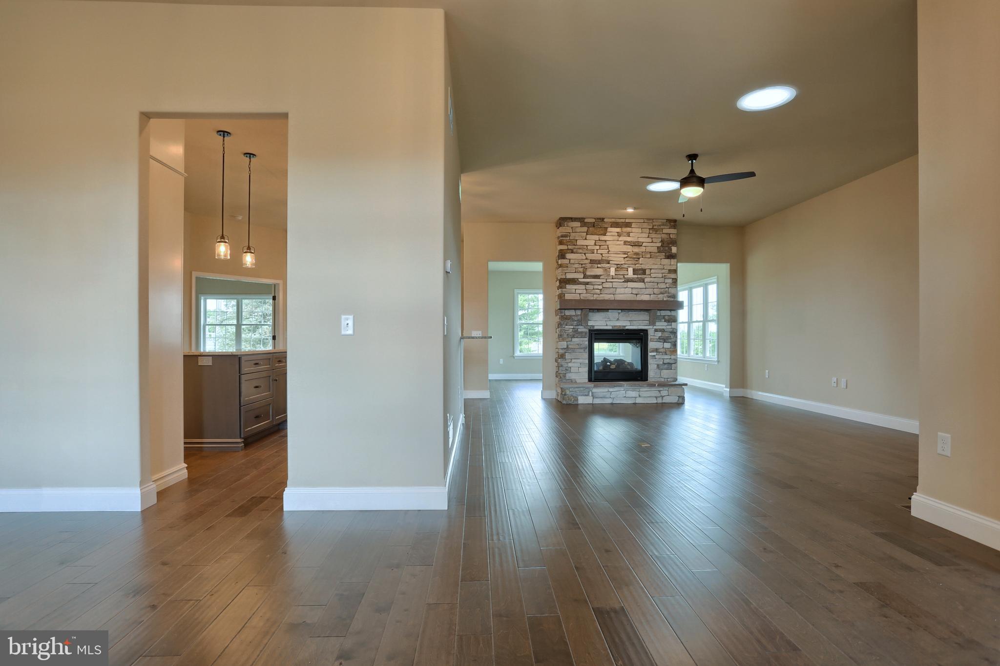 22 Rolling Meadow Road Lebanon, PA 17046 - Photo 8 of 38 a view of a livingroom with a fireplace wooden floor and chandelier