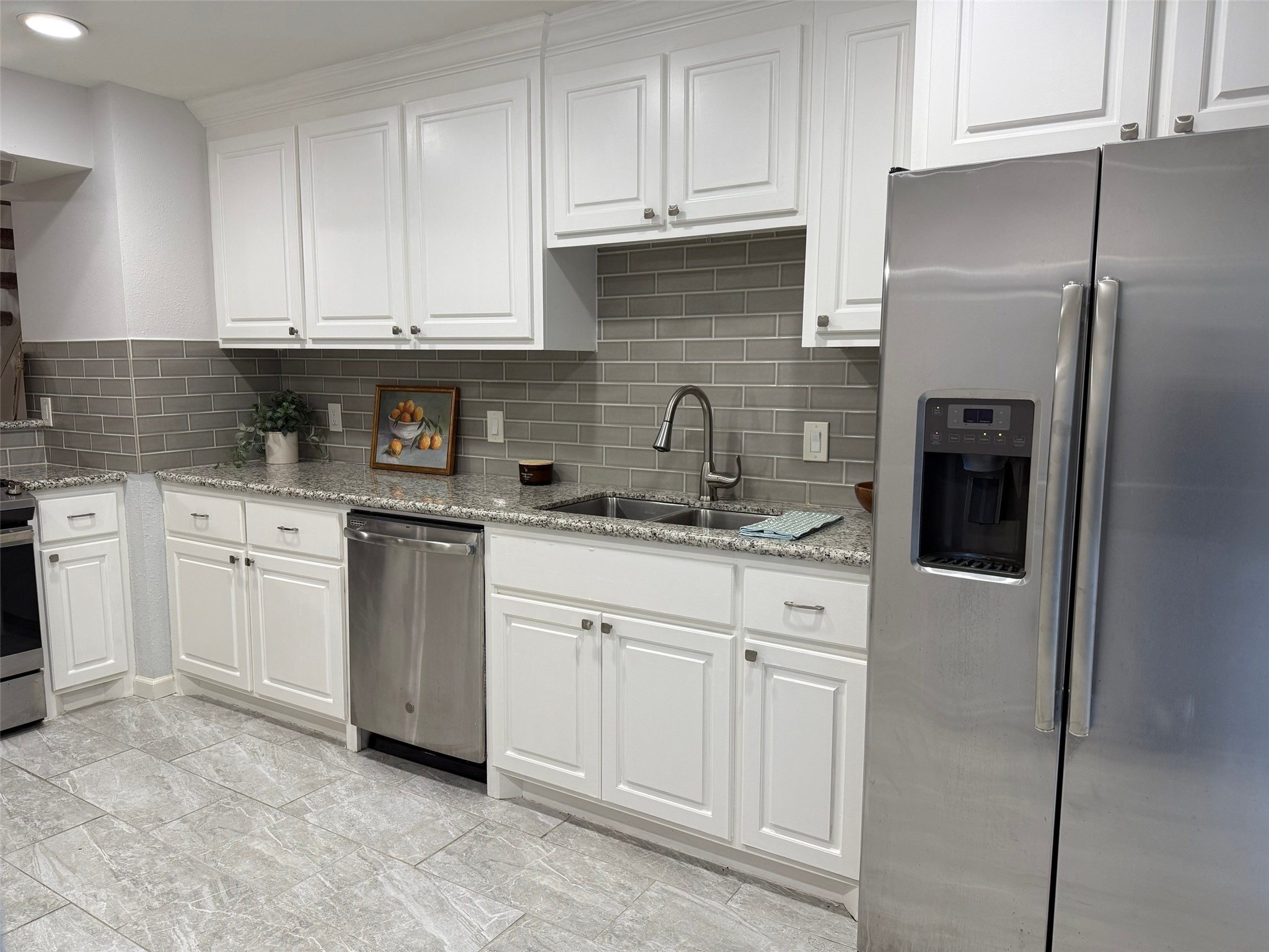 9626 Magnolia Ridge Drive Houston, TX 77070 - Photo 13 of 40 a kitchen with stainless steel appliances granite countertop a refrigerator sink and cabinets