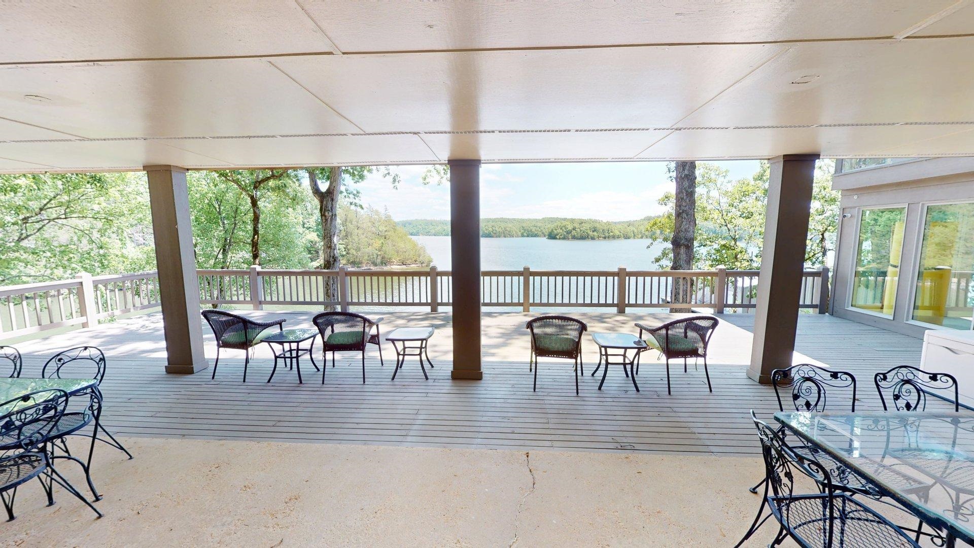 50 Cr 396 Road Iuka, MS 38852 - Photo 35 of 40 Expansive covered deck featuring a lake backdrop, wood-finish decking, and open-air railing