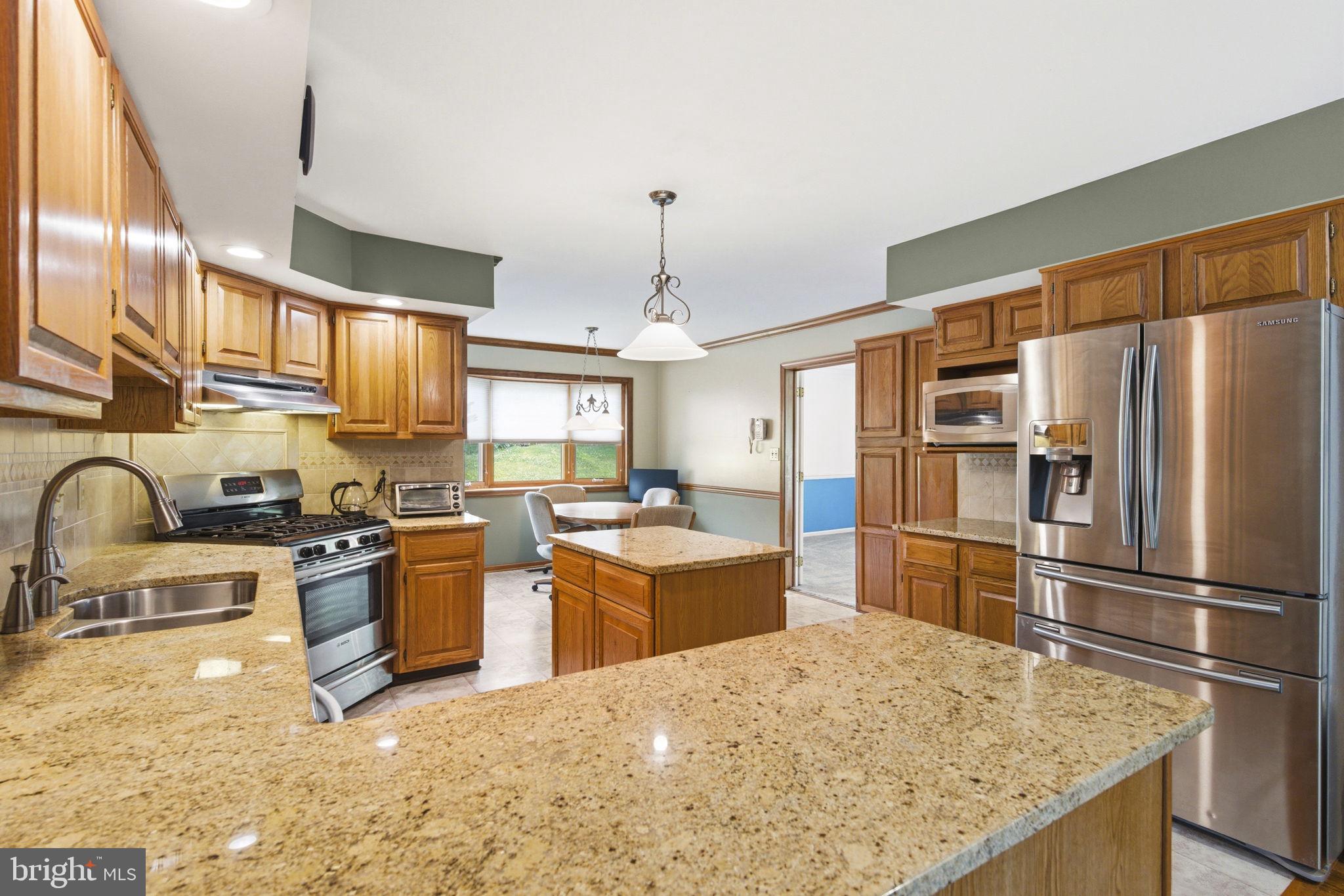736 Letitia Drive Hockessin, DE 19707 - Photo 38 of 92 a kitchen with stainless steel appliances granite countertop a sink stove and refrigerator