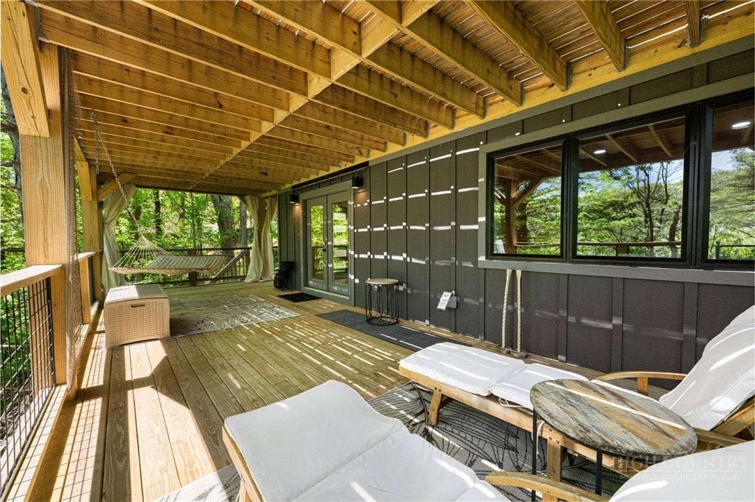 1385 Niley Cook Road Blowing Rock, NC 28605 - Photo 34 of 40 a outdoor space with the couches and dining table with the wooden floor