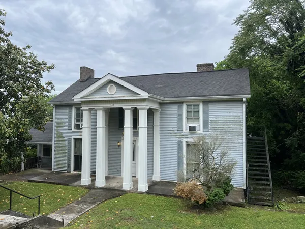 a front view of a house with garden