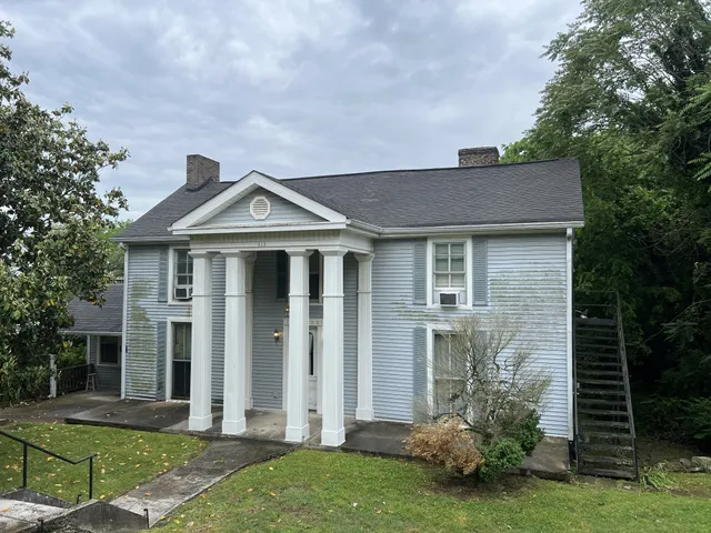 a front view of a house with garden