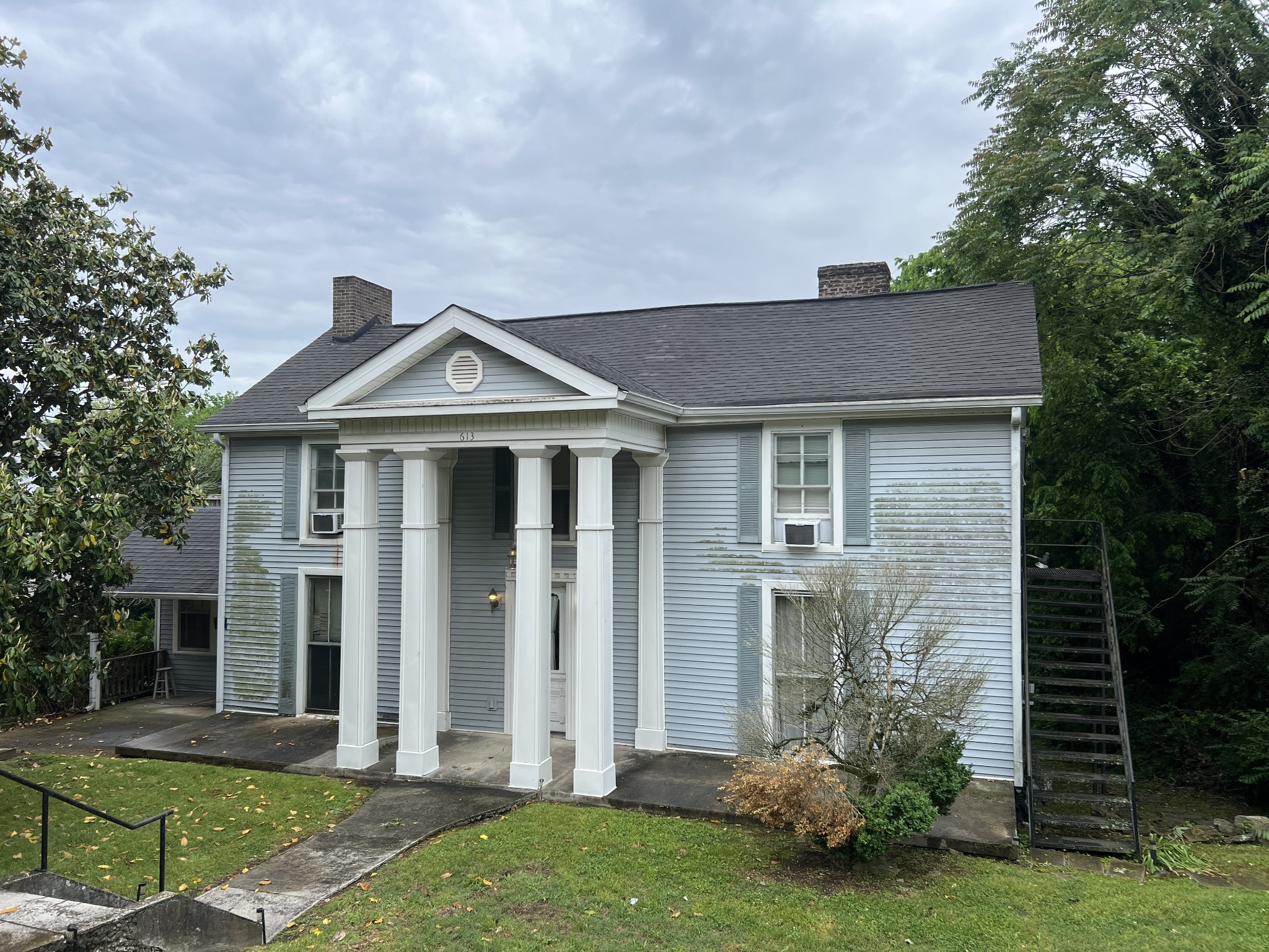 a front view of a house with garden