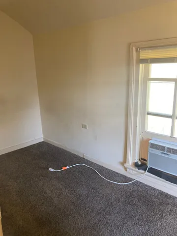 a white kitchen with wooden floor