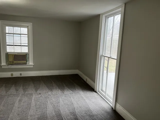 a view of a livingroom with a fireplace and a sink