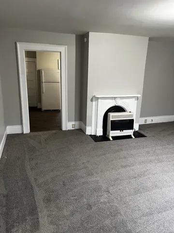 a room with a refrigerator and a stove top oven