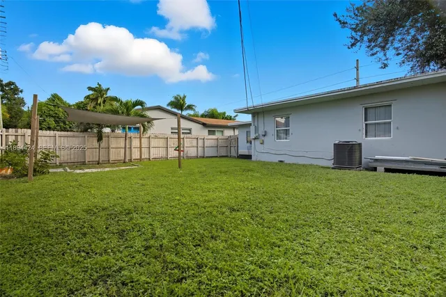 an aerial view of residential houses with outdoor space and swimming pool