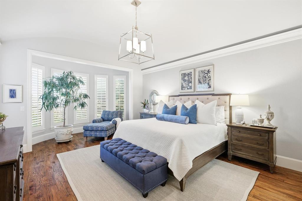 921 Winding Ridge Trail Southlake, TX 76092 - Photo 18 of 40 a bedroom with a large bed and a chandelier