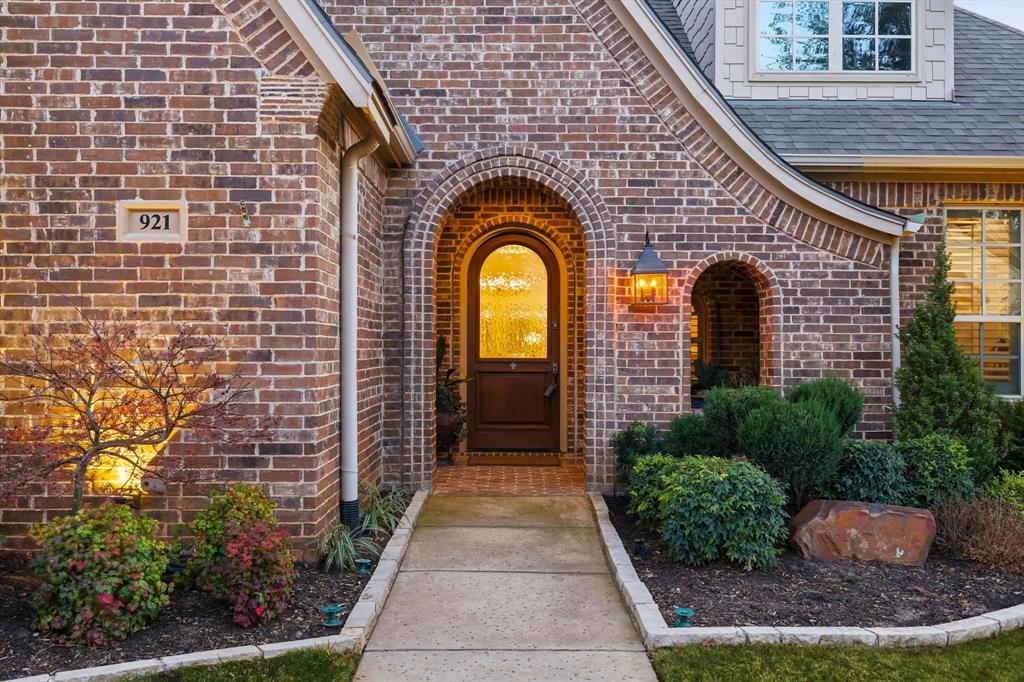 921 Winding Ridge Trail Southlake, TX 76092 - Photo 2 of 40 a view of a brick house with potted plants